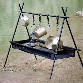 Folding camping hanger rack holding cookware above a fabric storage sling