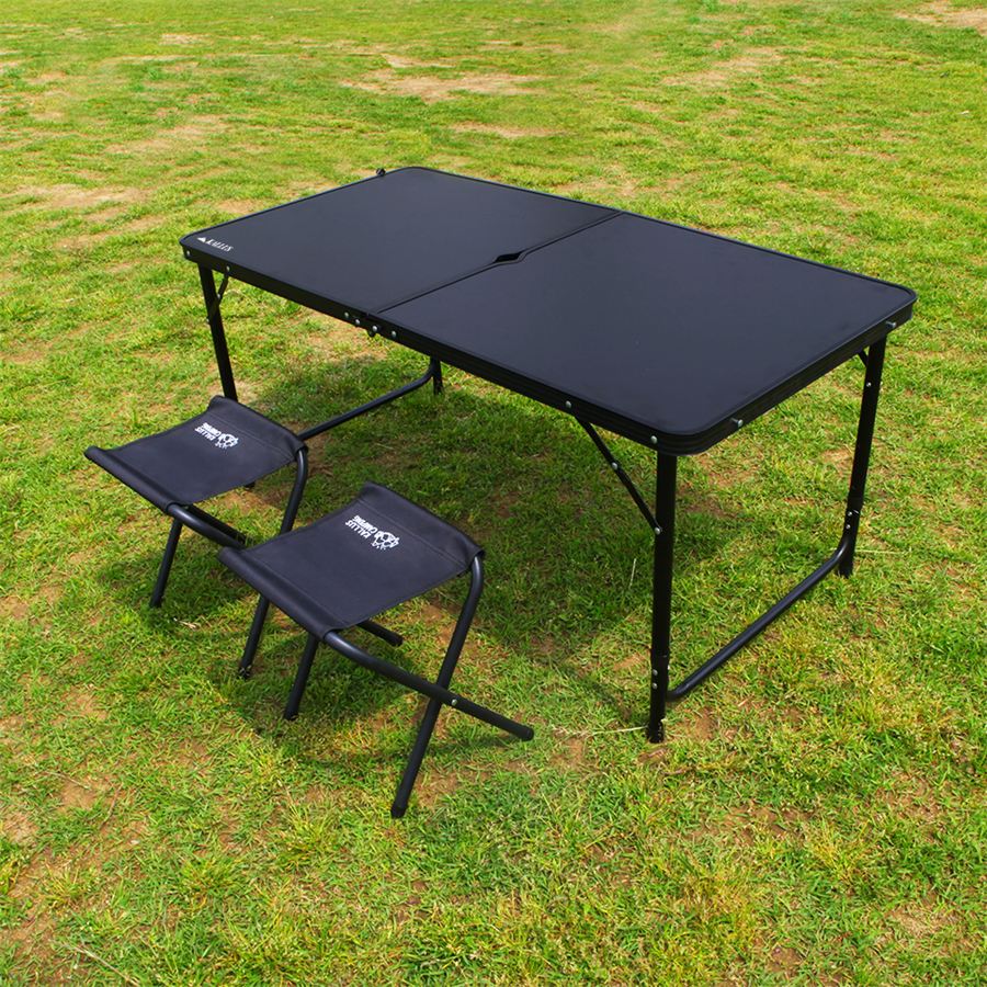 KALLUS black folding camping table with two matching folding stools on grass