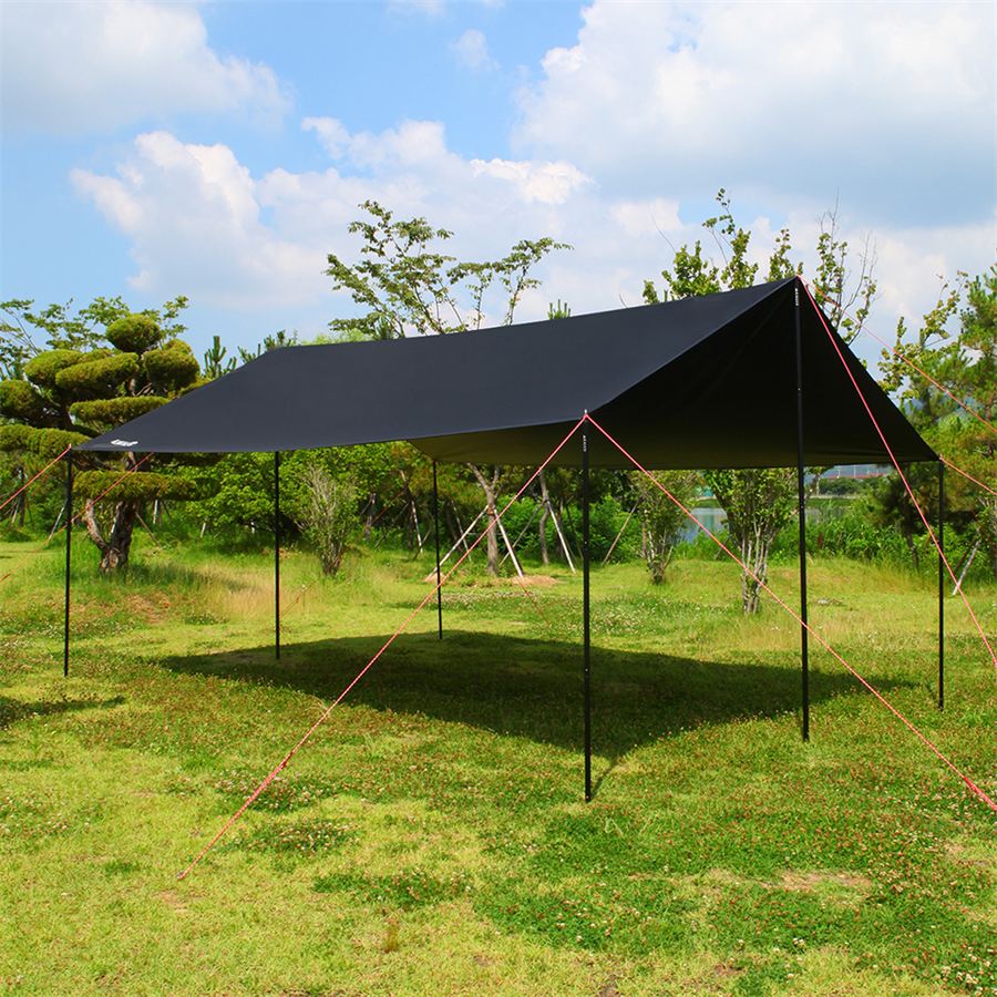 KALLUS black rectangular camping tarp pitched with poles and guylines on a grass field